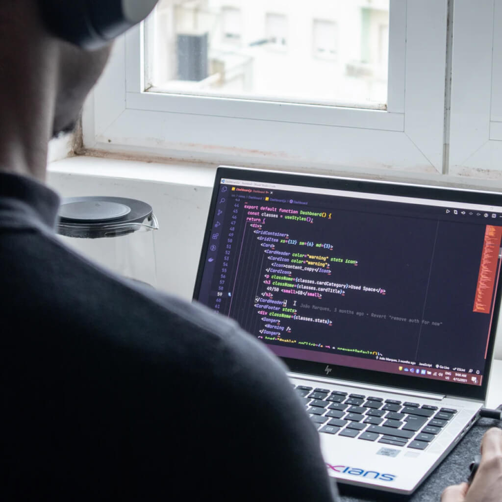 Man coding on laptop